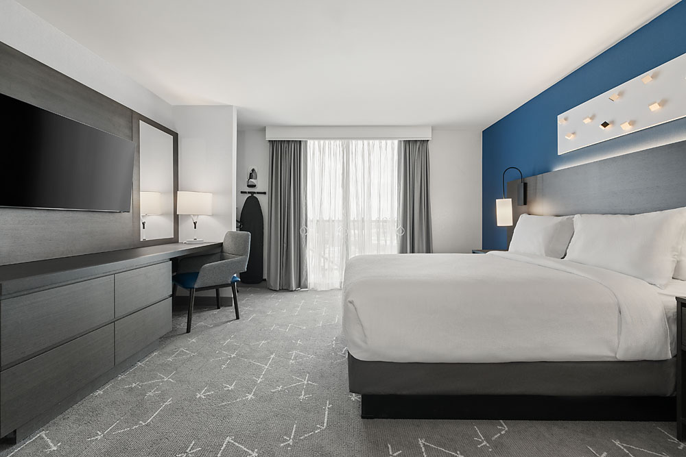 Comfortable two-room suite featuring a separate bedroom with plush bedding.