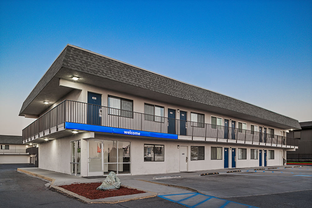 Front exterior of Motel 6 Twin Falls with signage and blue sky